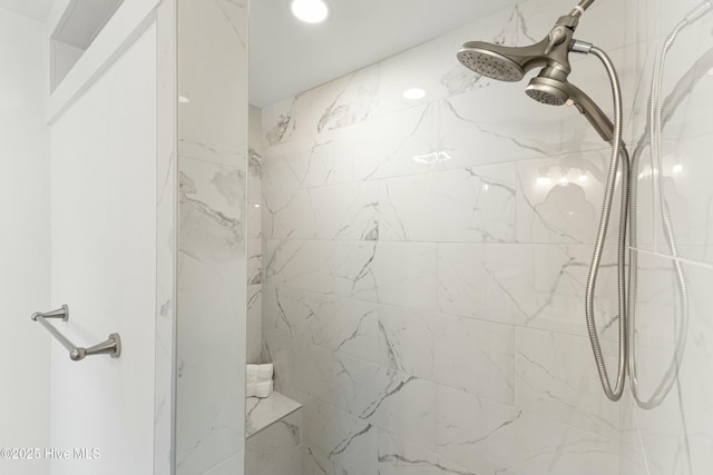 full bath with a marble finish shower