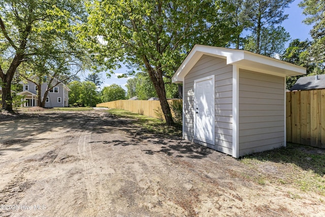 view of shed featuring fence