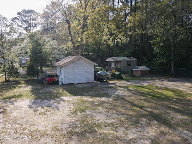 exterior space featuring fence and a shed