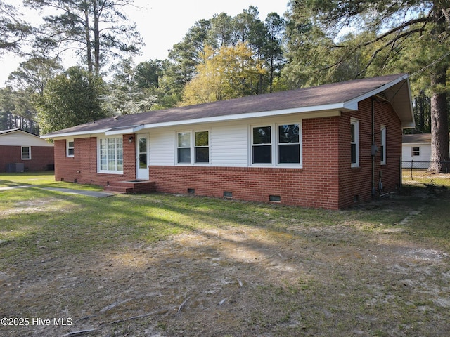 ranch-style house with crawl space, a front yard, central AC unit, brick siding, and fence