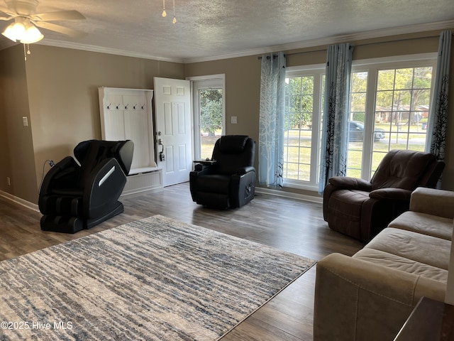 living area with french doors, ceiling fan, ornamental molding, and wood finished floors