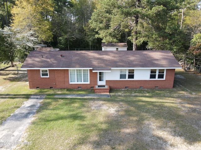 single story home featuring roof with shingles, a front lawn, brick siding, and crawl space