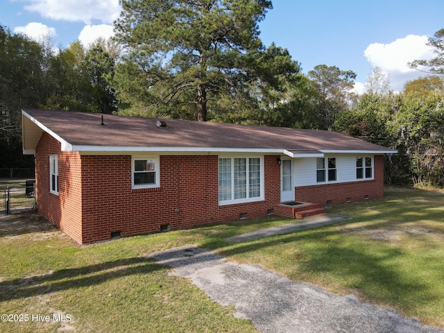 ranch-style home featuring brick siding, crawl space, fence, and a front yard