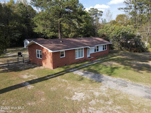 ranch-style house featuring fence, a front yard, brick siding, and crawl space