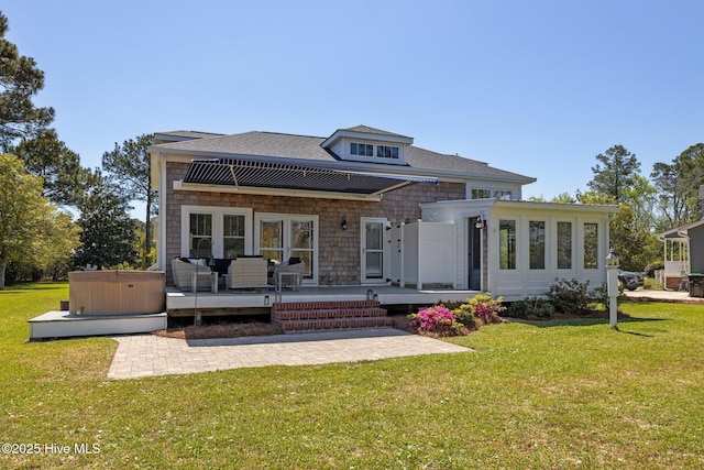 rear view of property with an outdoor living space, a lawn, and a patio