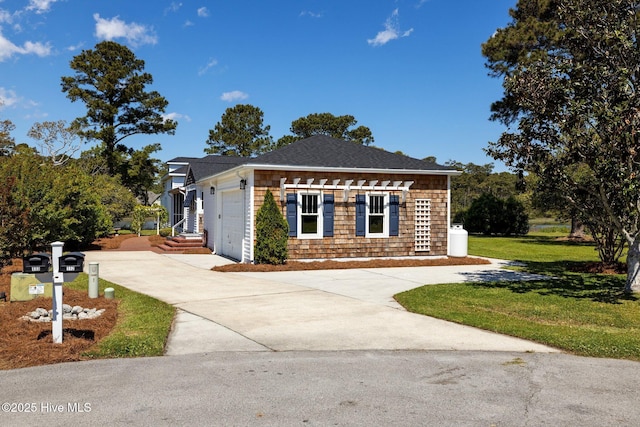view of front facade with concrete driveway, a garage, and a front yard