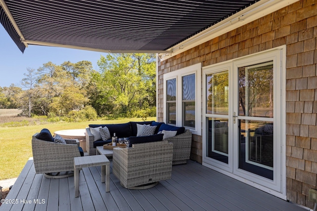 wooden deck featuring a lawn and outdoor lounge area