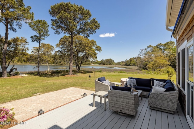 wooden deck with an outdoor living space, a patio area, a yard, and a water view