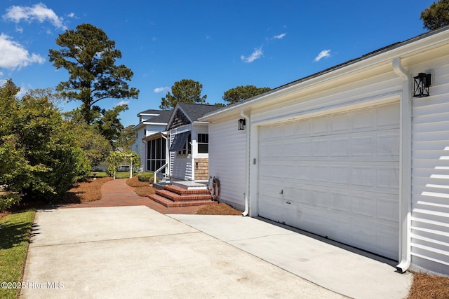 view of home's exterior with a garage and concrete driveway