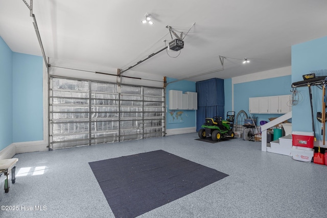 garage featuring baseboards and a garage door opener