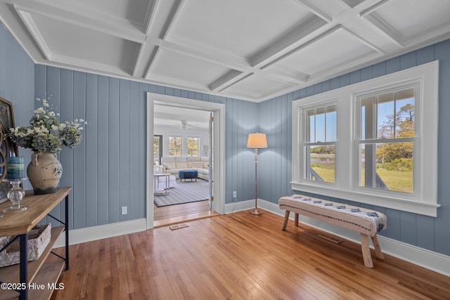 sitting room with coffered ceiling, beam ceiling, wood finished floors, and baseboards