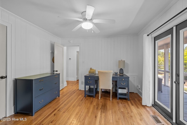 office featuring a ceiling fan, ornamental molding, visible vents, and light wood-type flooring