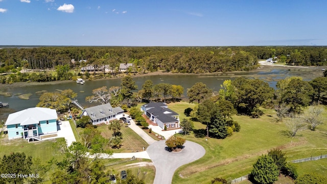 birds eye view of property with a forest view and a water view