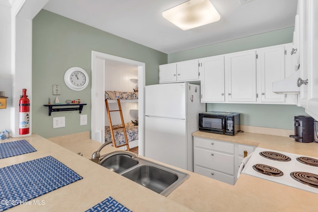 1437 Fort Fisher Blvd S Unit C2, Kure Beach, NC 28449 - kitchen featuring white appliances, light countertops, a sink, and white cabinets