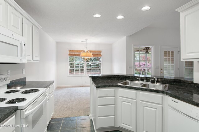 1710 Bay Tree Ct SW, Ocean Isle Beach, NC 28469 - kitchen with white cabinetry, a sink, a healthy amount of sunlight, and white appliances