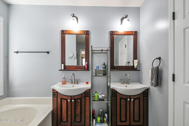 full bath featuring a sink, a bath, and two vanities
