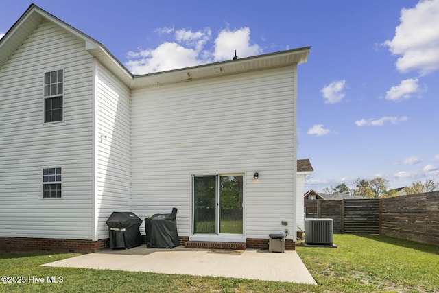back of property featuring a patio, central AC unit, fence, and a lawn