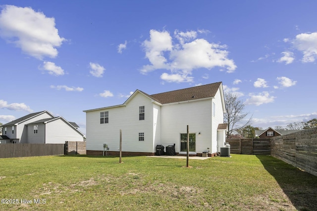 rear view of property featuring cooling unit, a patio, a yard, and a fenced backyard