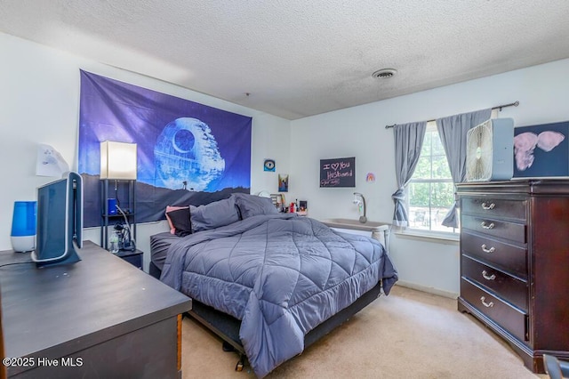 carpeted bedroom featuring visible vents and a textured ceiling