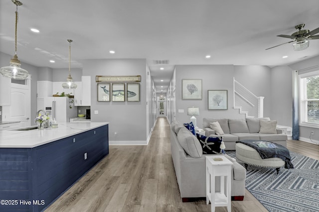 732 Avila Ave, Hampstead, NC 28443 - living area featuring wood finished floors, recessed lighting, stairway, a ceiling fan, and baseboards