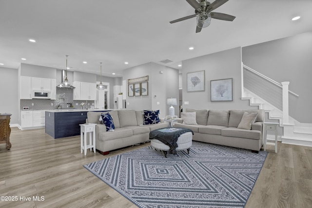 732 Avila Ave, Hampstead, NC 28443 - living room with ceiling fan, stairway, light wood-style flooring, and recessed lighting
