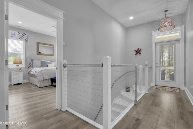732 Avila Ave, Hampstead, NC 28443 - hallway featuring plenty of natural light, wood finished floors, baseboards, recessed lighting, and an upstairs landing