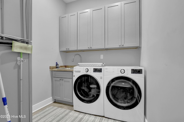 732 Avila Ave, Hampstead, NC 28443 - laundry area with cabinet space, washing machine and clothes dryer, baseboards, and light wood finished floors