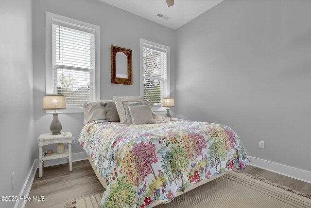 732 Avila Ave, Hampstead, NC 28443 - bedroom featuring baseboards, wood finished floors, and a ceiling fan