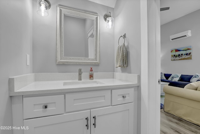 732 Avila Ave, Hampstead, NC 28443 - bathroom with vanity, wood finished floors, and a wall mounted air conditioner