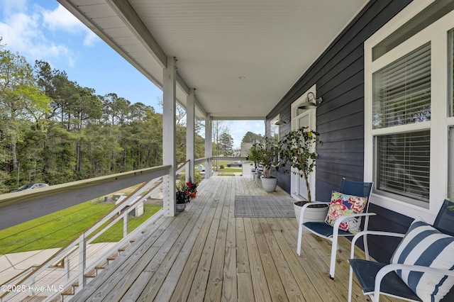 732 Avila Ave, Hampstead, NC 28443 - wooden deck featuring covered porch