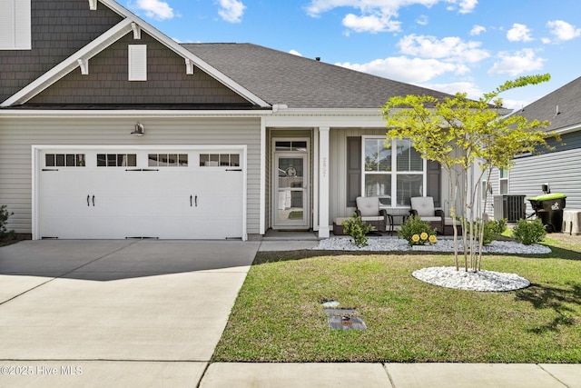view of front of home with a garage, central air condition unit, a porch, a front yard, and driveway