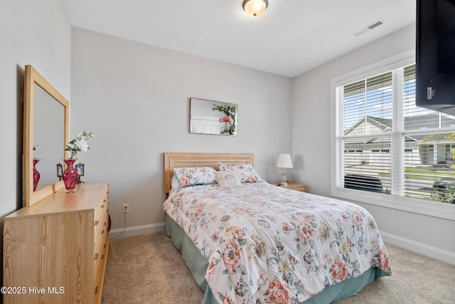 bedroom with visible vents, baseboards, and light colored carpet