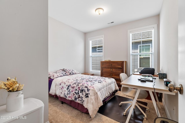 carpeted bedroom with visible vents