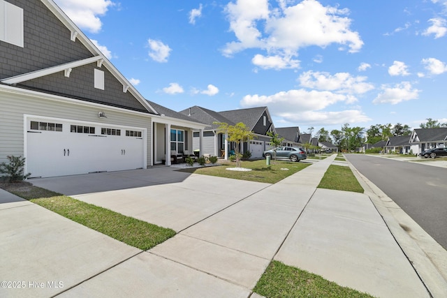 exterior space with a residential view, driveway, and an attached garage