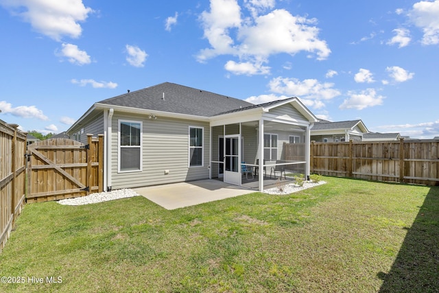back of property featuring a sunroom, a lawn, a fenced backyard, a patio, and a gate