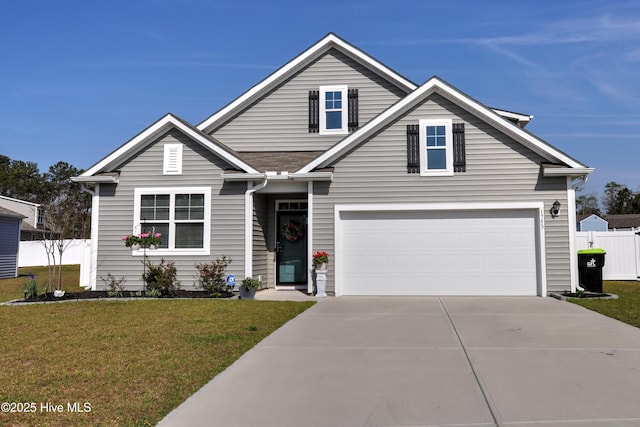 view of front facade featuring fence, a front lawn, and concrete driveway