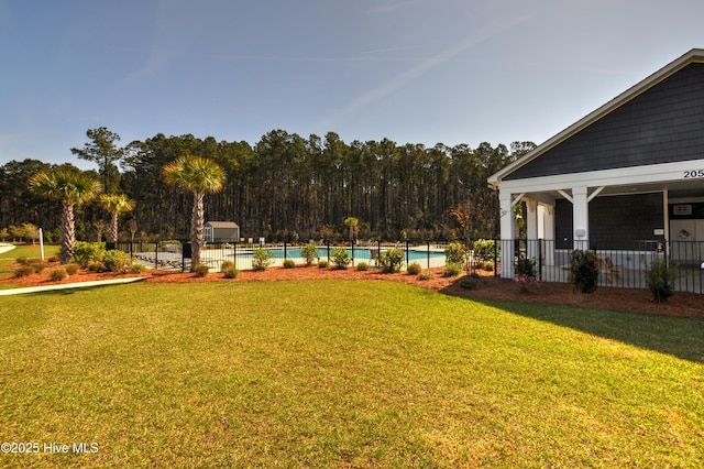 view of yard with a community pool and fence