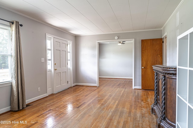 entryway with a ceiling fan, ornamental molding, hardwood / wood-style flooring, and baseboards