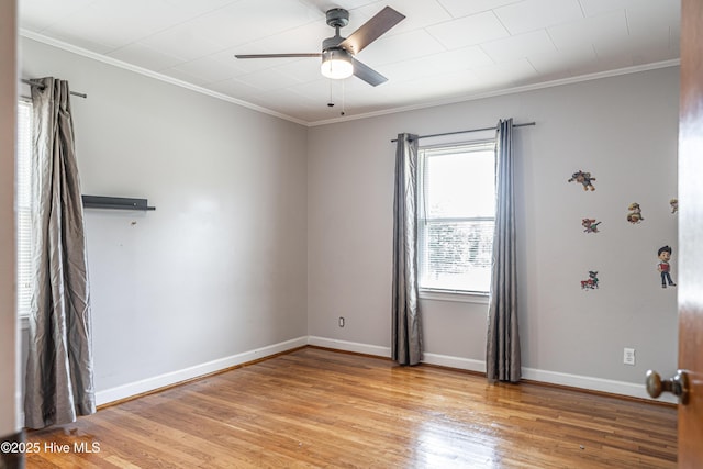 unfurnished room with baseboards, ceiling fan, light wood-style floors, and ornamental molding