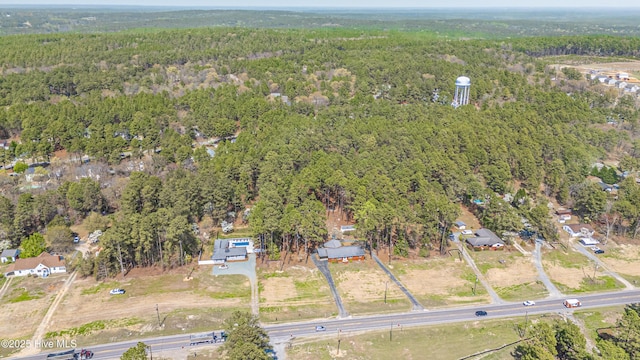 birds eye view of property featuring a wooded view