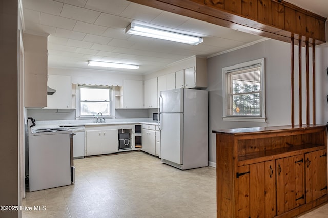 kitchen with light countertops, white appliances, ornamental molding, a sink, and open shelves