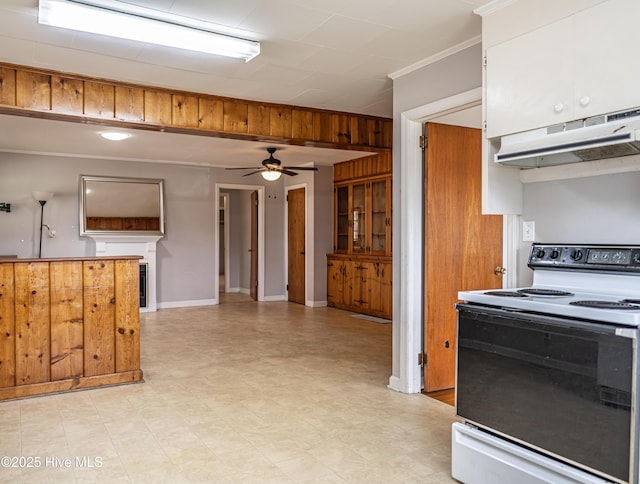 kitchen featuring a ceiling fan, under cabinet range hood, range with electric cooktop, white cabinets, and ornamental molding