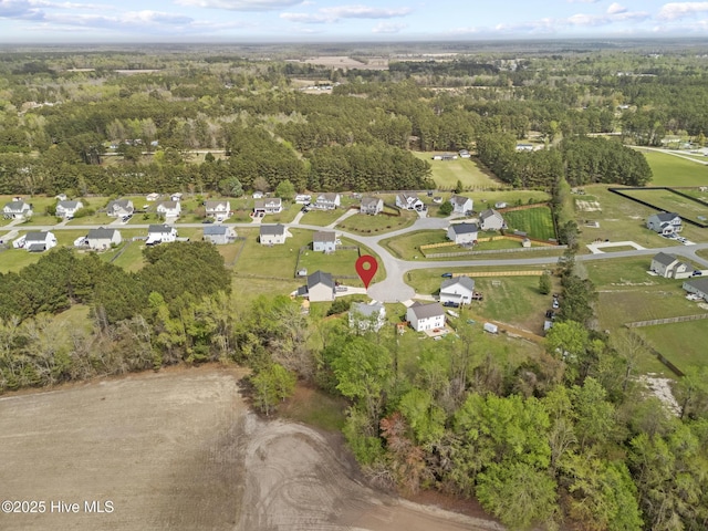 drone / aerial view featuring a view of trees
