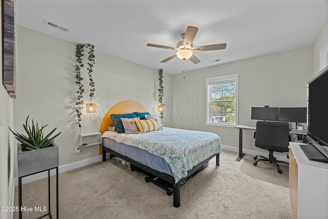 carpeted bedroom with baseboards, a ceiling fan, and visible vents