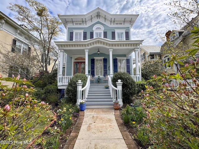 italianate-style house with a porch and stairway
