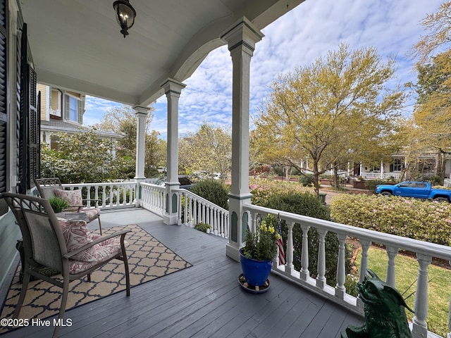 wooden terrace with a porch
