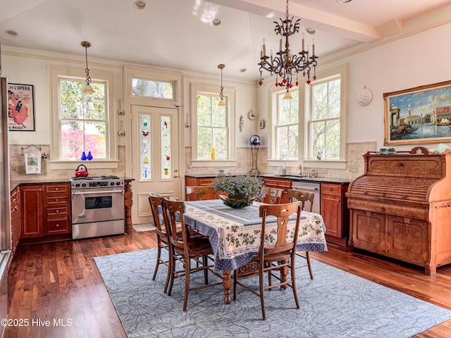 dining room featuring a chandelier, ornamental molding, dark wood-style flooring, and recessed lighting