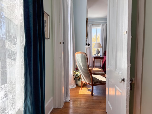 hallway with baseboards and wood finished floors