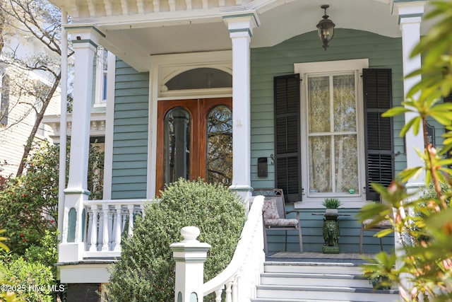 doorway to property featuring covered porch