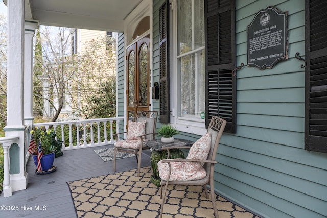 wooden terrace featuring covered porch